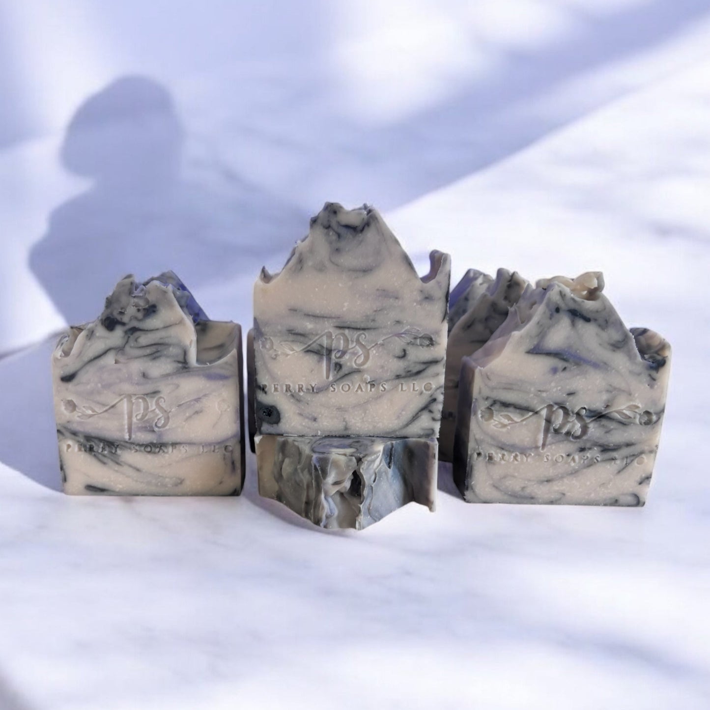 gray square soap bar with some black waves through it