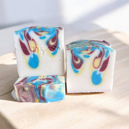 square bar of soap with light blue, yellow and burgundy swirls