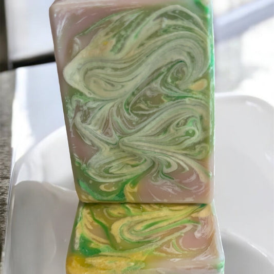 rectangle soap bar light in color with swirls of yellow and green on top