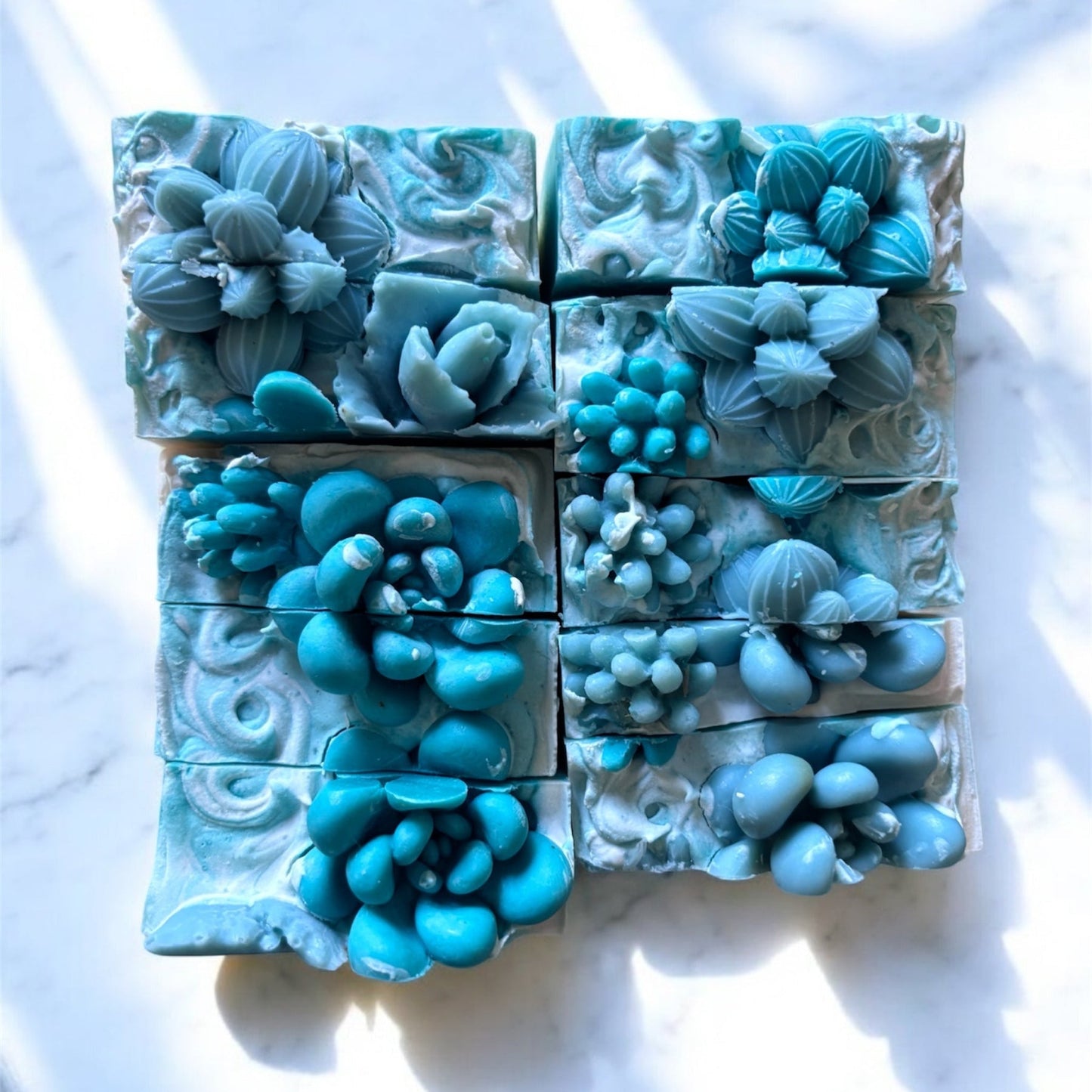 white square bar with green swirls and green esceveria on top