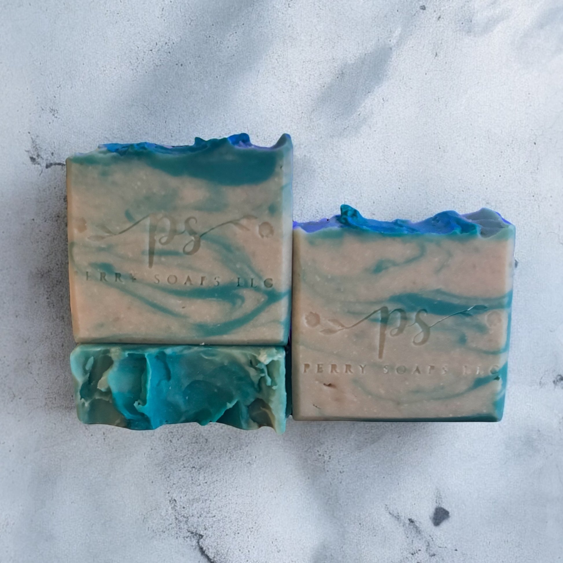 square soap with teal accents and white background