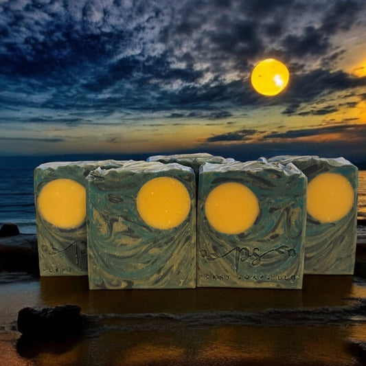 bars of soap in swirls of blue black and gray with a large orange moon circle in the top corner similar to a van gogh painting